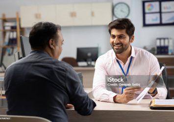 Customer with bank manager in office